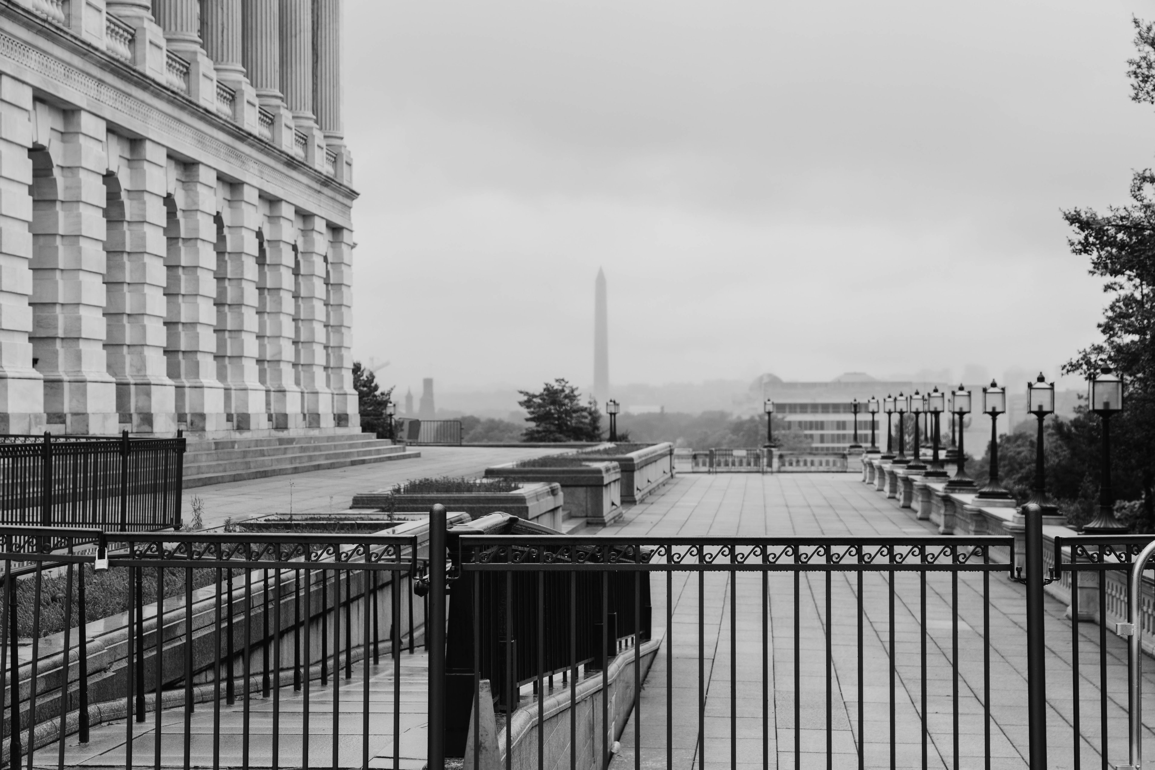 Black-and-white view of classical architecture and the Washington Monument