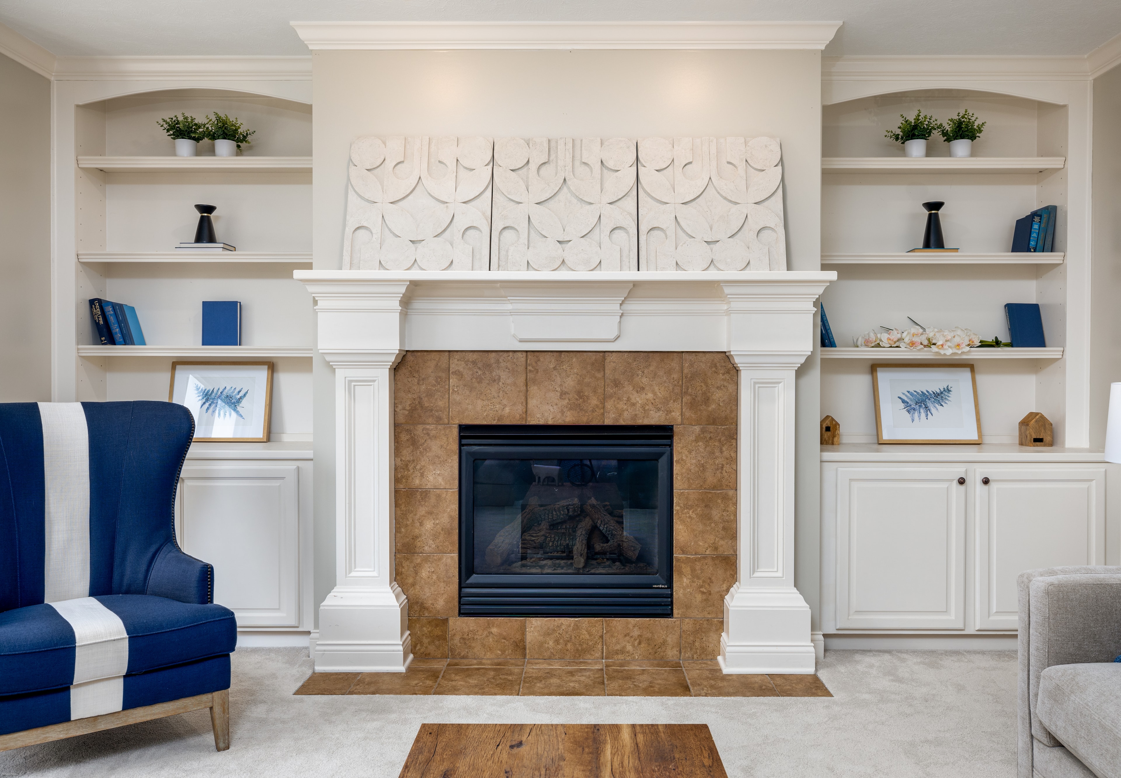 Bright residential living room with fireplace and built-in shelving